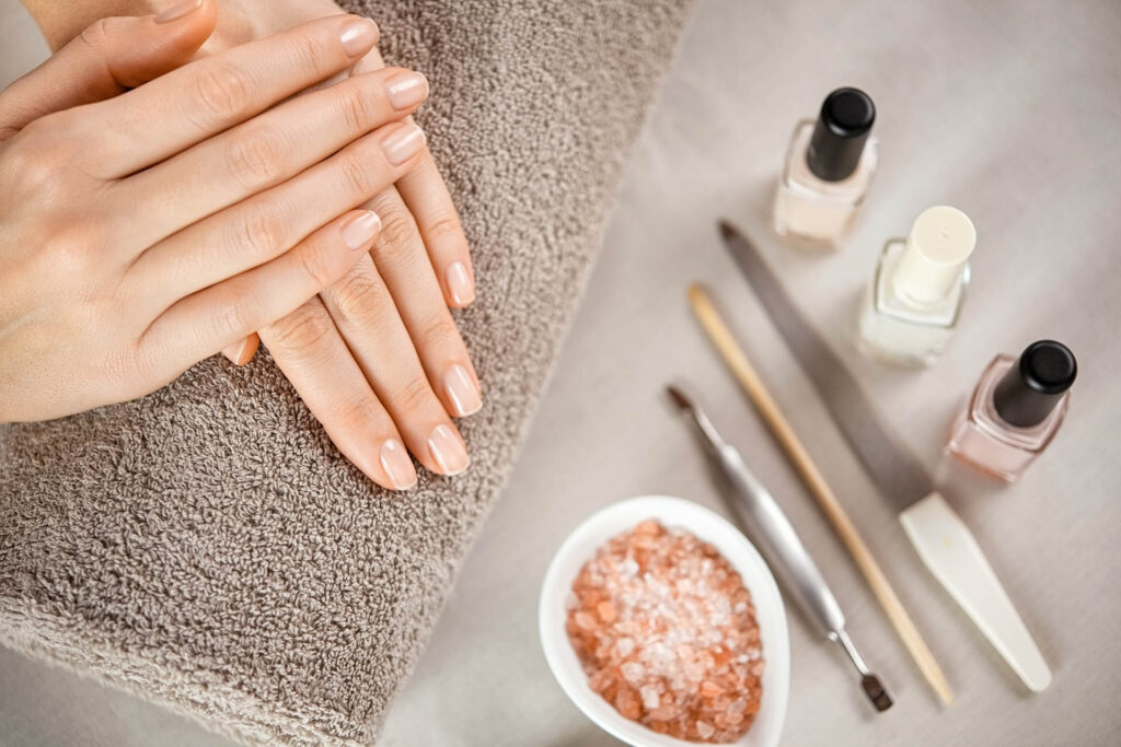 Woman,Fingers,With,Beautiful,Nails,On,Brown,Towel,With,Manicure